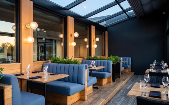 Restaurant patio with blue booths at Cascades Langley